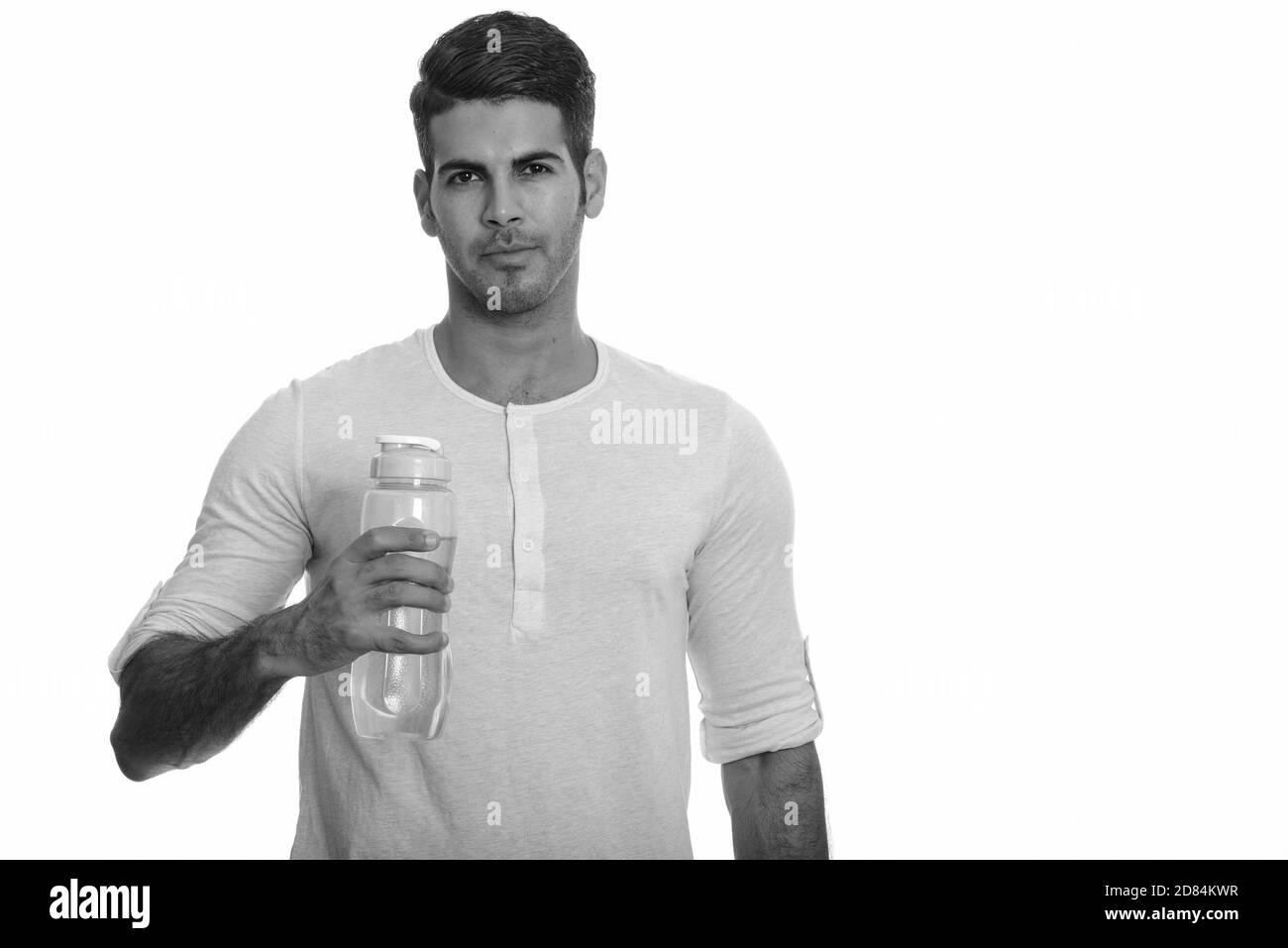 Young handsome Persian man holding water bottle Stock Photo - Alamy