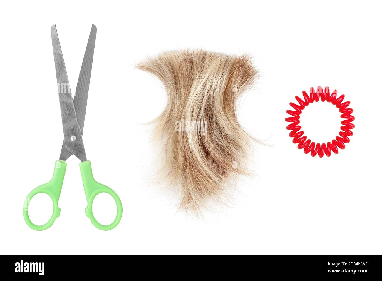 Blond hair lock, metal scissors, scrunchy white background isolated closeup, cut off blonde hair curl, steel shears, spiral hair band, hairstyle Stock Photo
