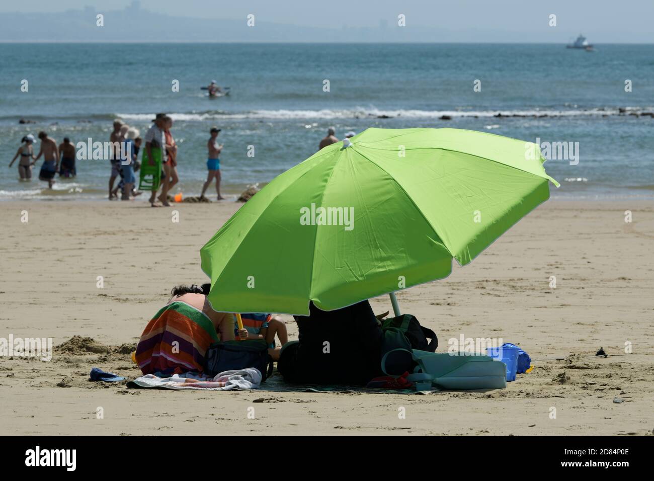 Umbrella on beach, people sitting in shade, landscape, Durban, KwaZulu