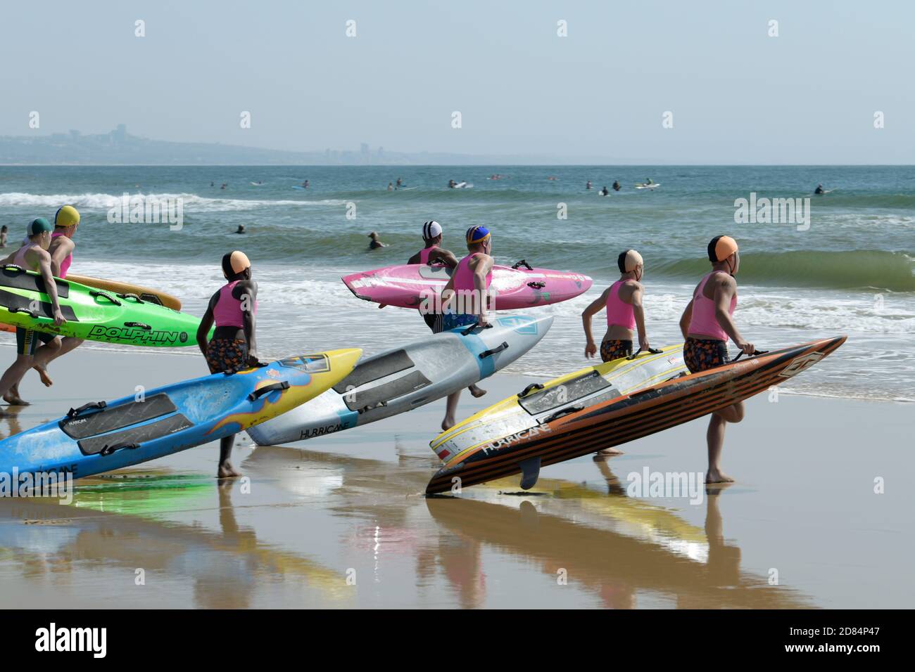 Seaside sport, boys running on beach, paddle board, surf lifesaving