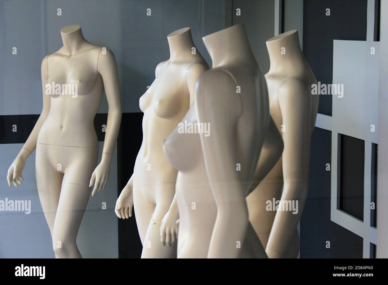 The window of empty clothing store in the commercial center of Athens, with mannequin dolls in the display - Athens, Greece, October 9 2020. Stock Photo