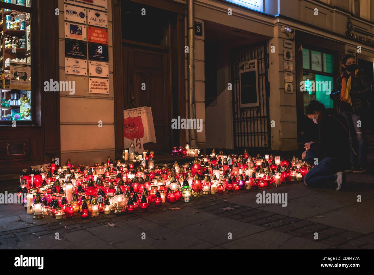 Lublin, Poland - October 23, 2020: Women putting down grave candle during protest by Strajk Kobiet against abortion ban in Poland Stock Photo