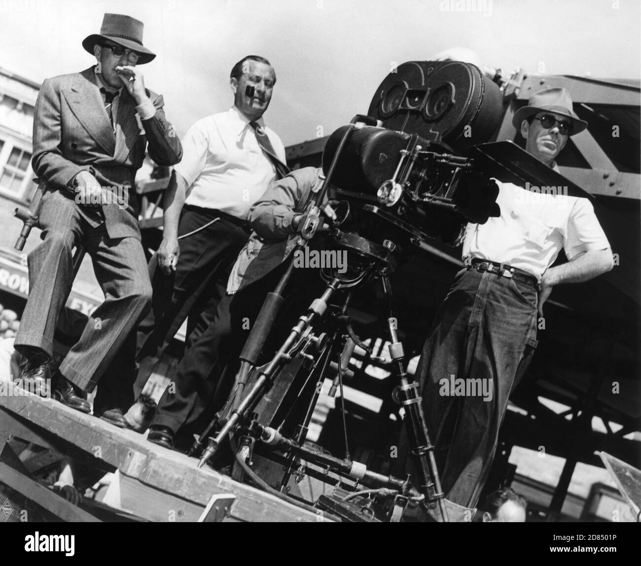Director RAOUL WALSH and Cinematographer ARTHUR EDISON on set candid with Camera Crew during filming of THEY DRIVE BY NIGHT 1940 director RAOUL WALSH associate producer Mark Hellinger executive producer Hal B. Wallis Warner Bros. Stock Photo