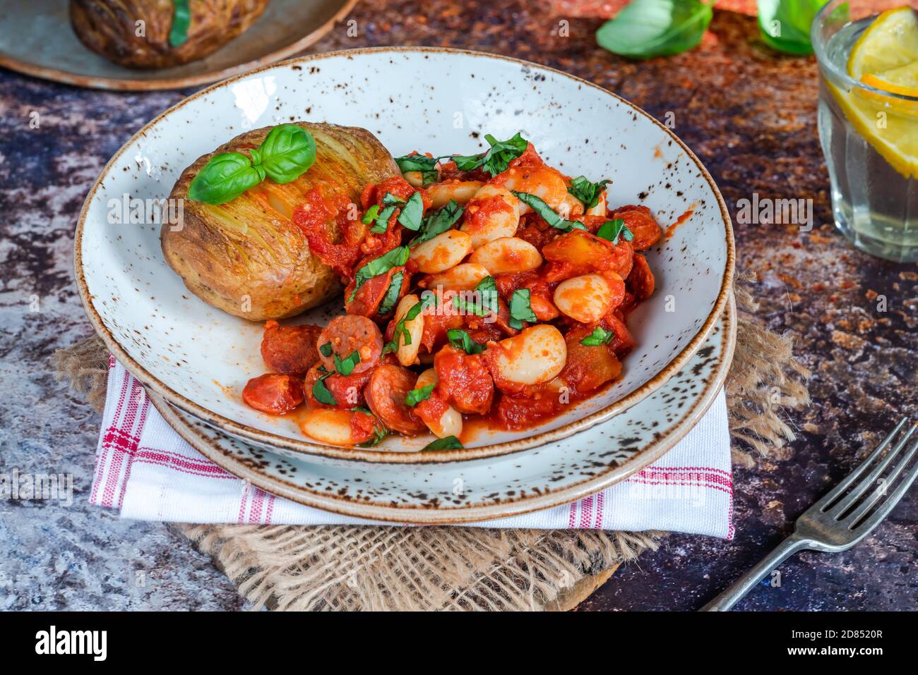 Chorizo and butterbean stew with baked jacket potato Stock Photo