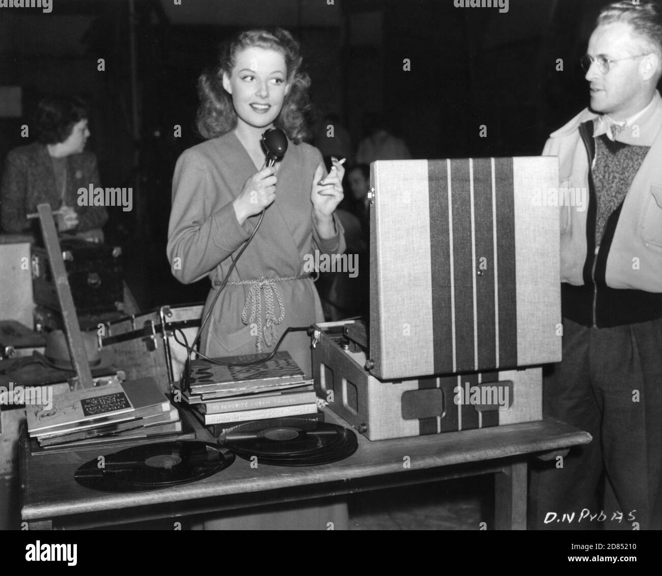 ANN SHERIDAN playing music from record player on set candid during filming of THEY DRIVE BY NIGHT 1940 director RAOUL WALSH associate producer Mark Hellinger executive producer Hal B. Wallis Warner Bros. Stock Photo