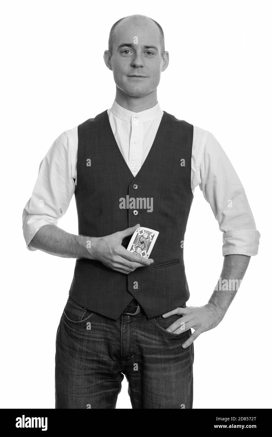 Bald Caucasian magician man holding Jack of Diamonds card with hand on hip Stock Photo