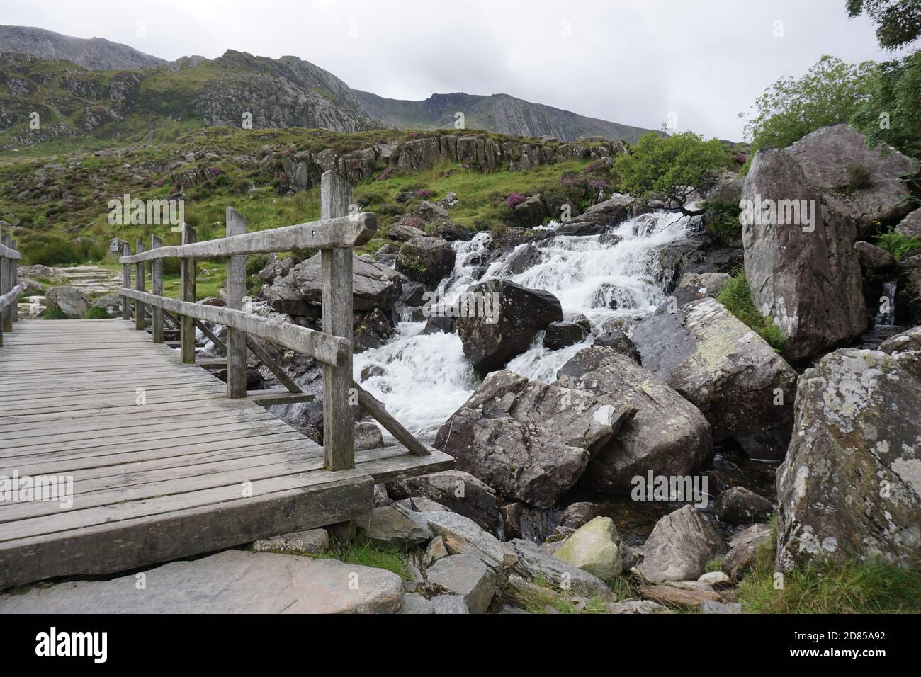 The old wooden bridge at the waterfall in Ogwen Valley Snowdonia North Wales UK Stock Photo