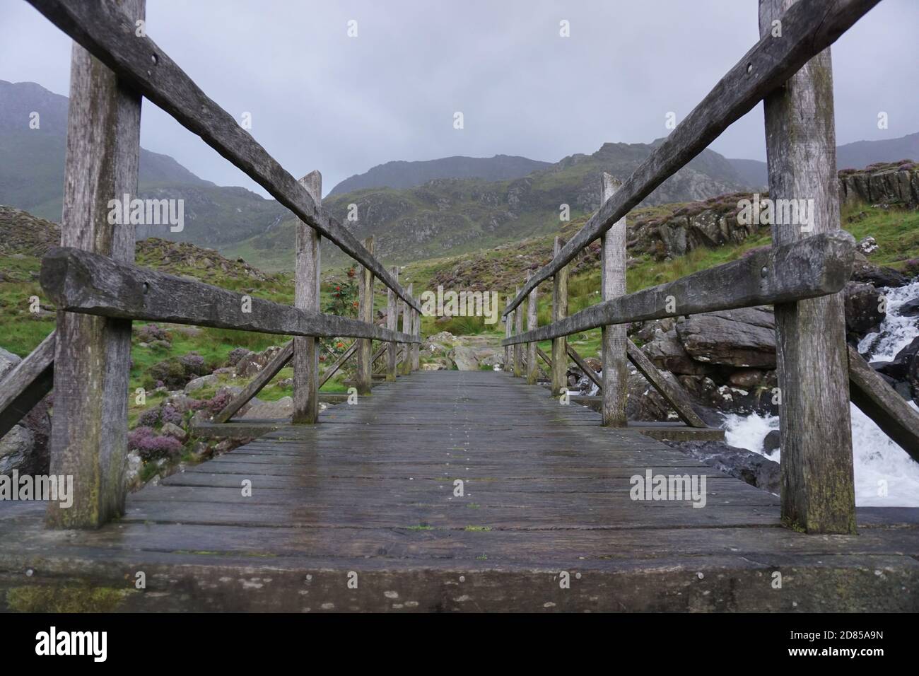 The old wooden bridge at the waterfall in Ogwen Valley Snowdonia North Wales UK Stock Photo