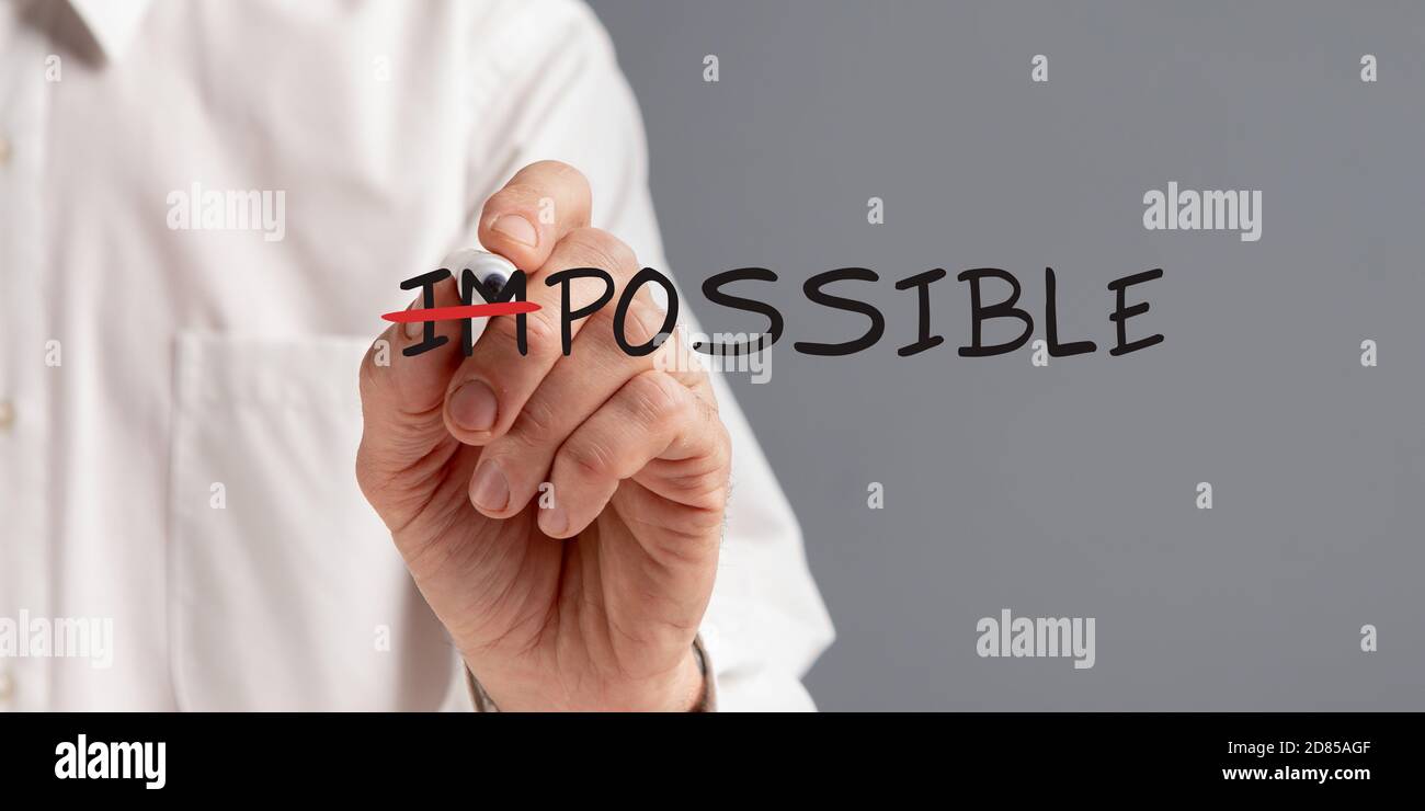 Businessman Crossing Out Word Impossible Making Everything Possible, Gray Background Stock Photo