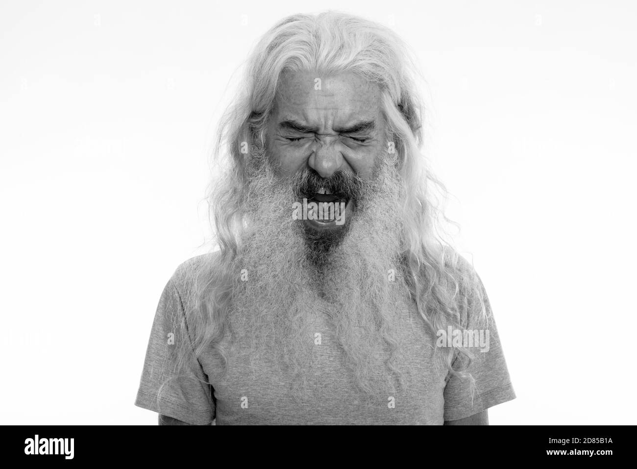 Studio shot of angry senior bearded man looking furious while shouting Stock Photo