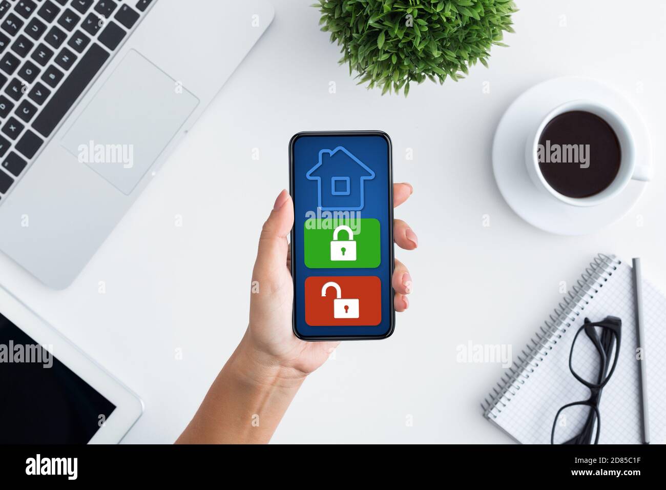 Lady using her cellphone with home security application Stock Photo