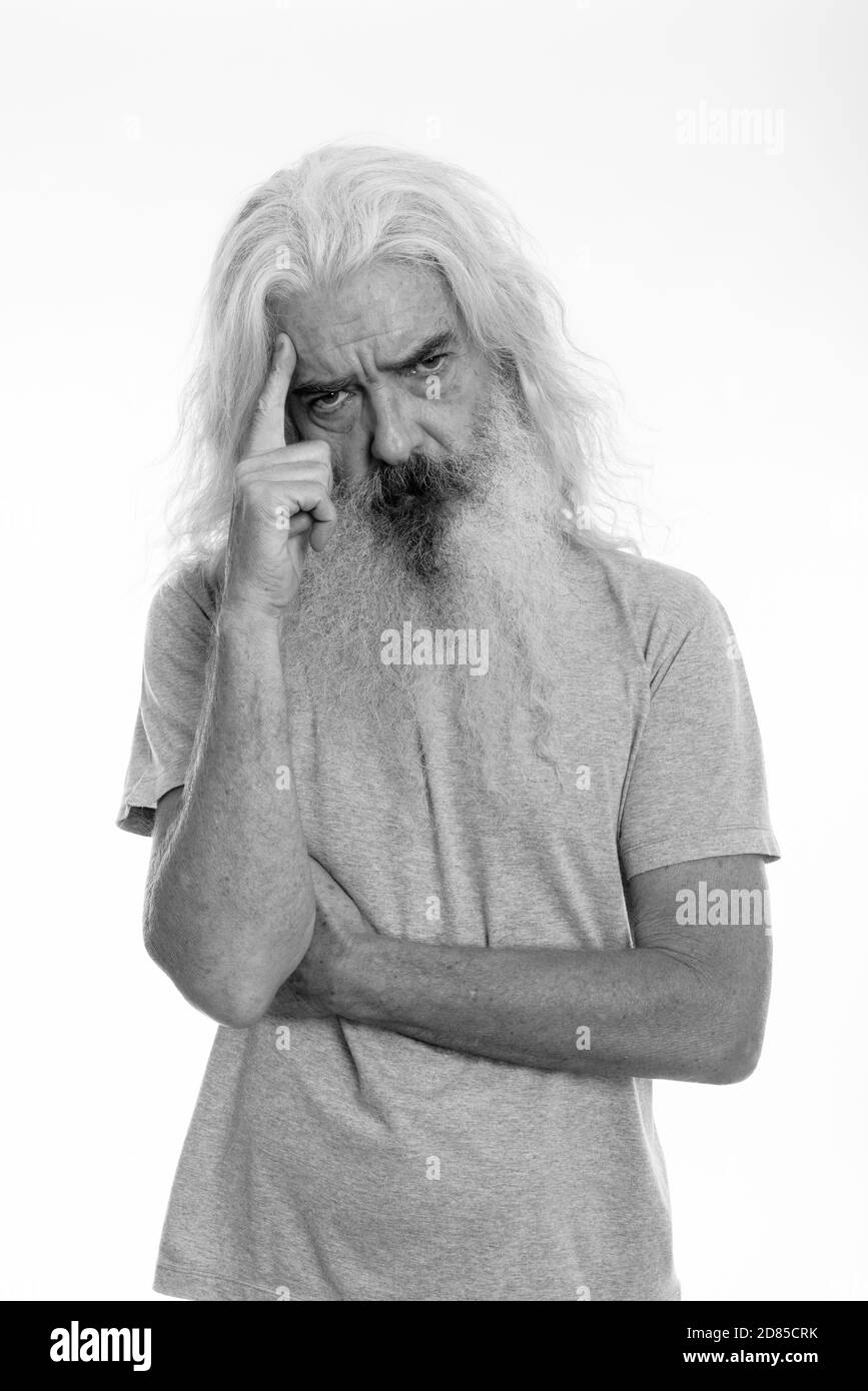 Studio shot of senior bearded man thinking with finger on head Stock Photo