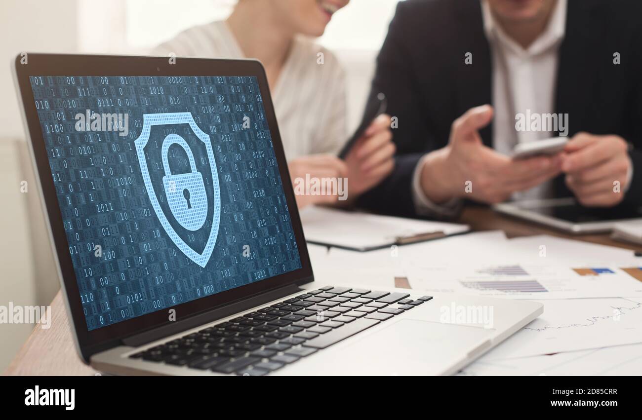 Laptop with closed padlock icon and binary code on screen Stock Photo