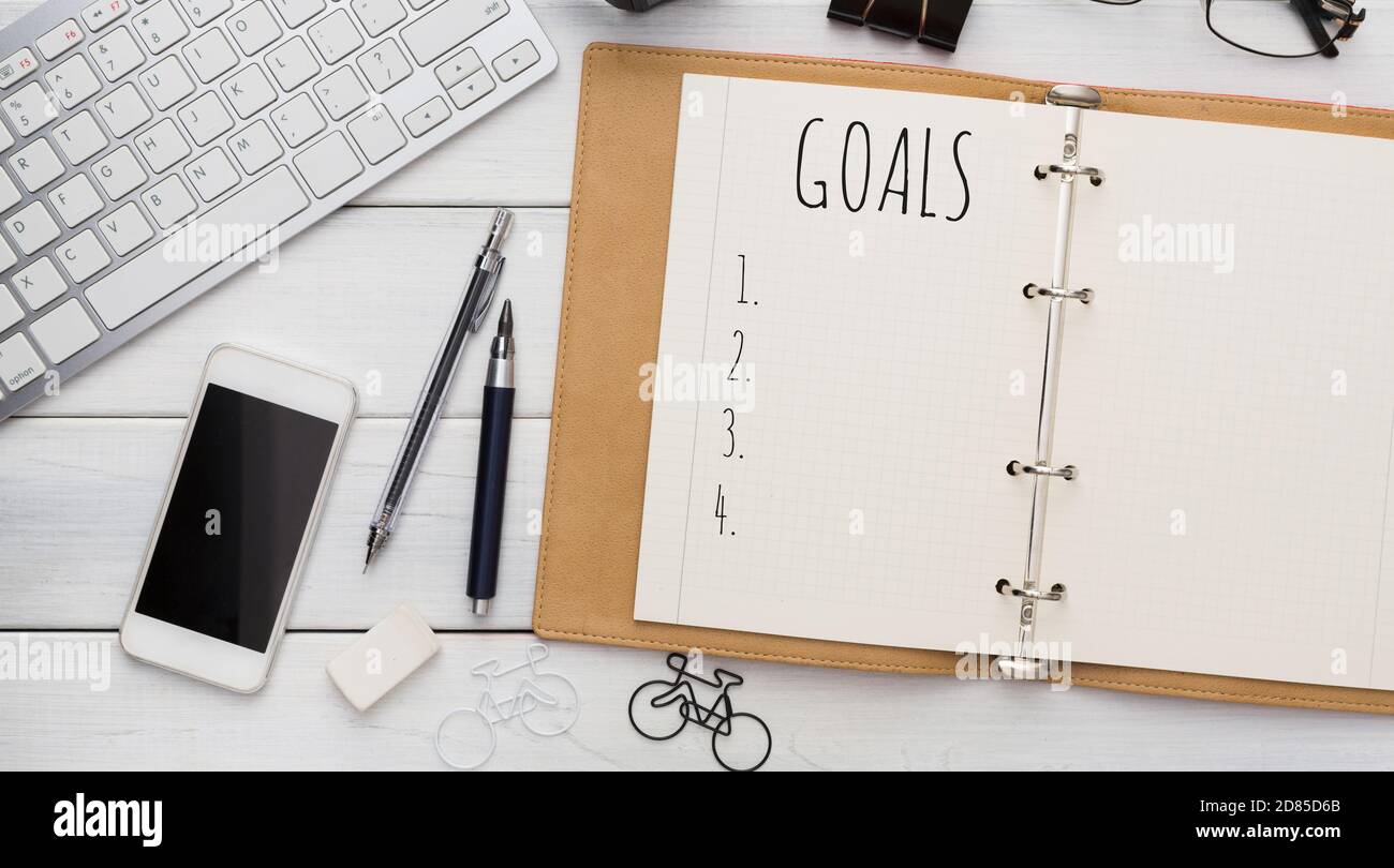Opened Notebook With Goals List On Modern Office Desk Background Stock Photo