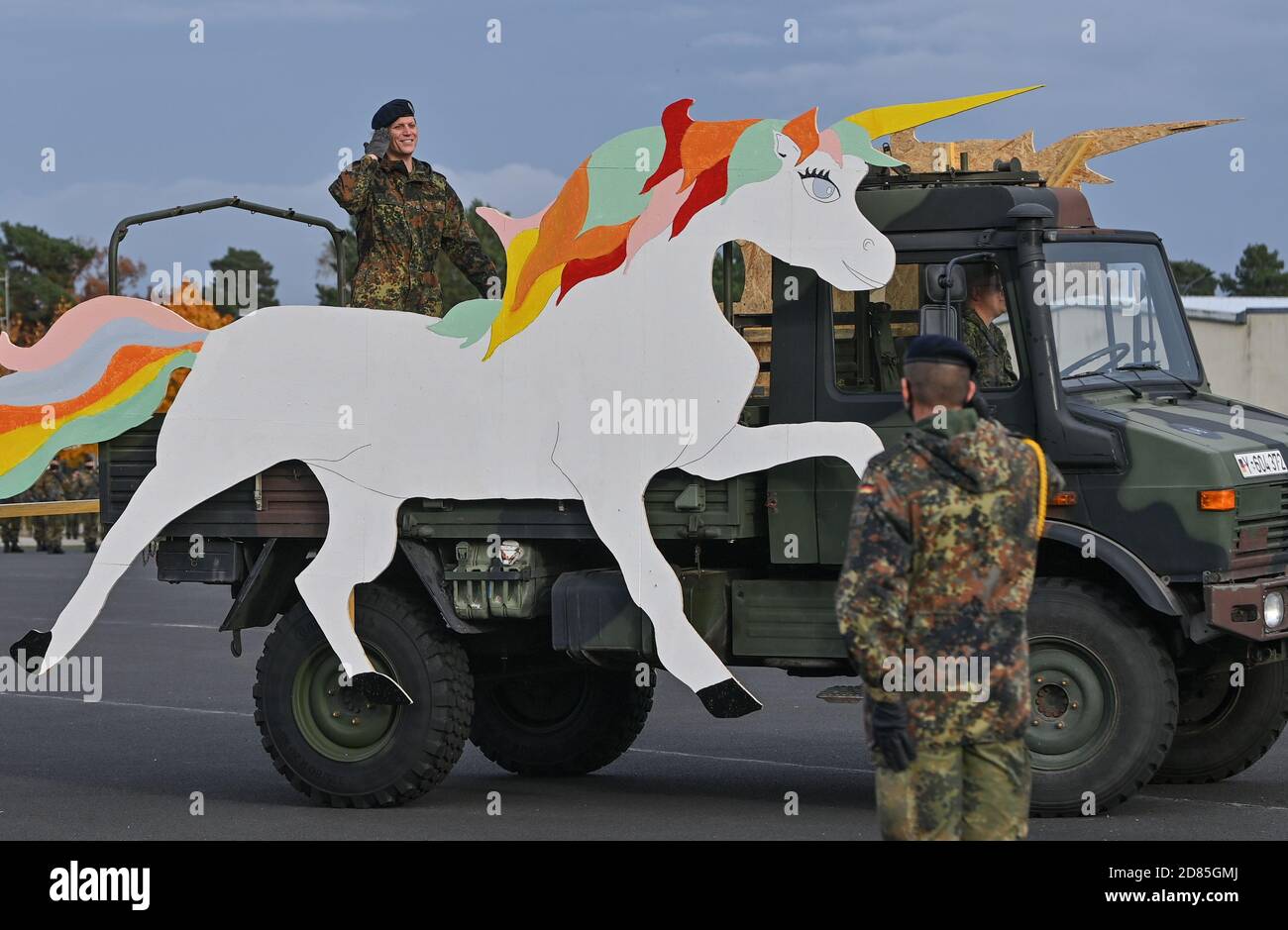 27 October 2020, Brandenburg, Storkow: Anastasia Biefang, commander of the  Information Technology Battalion 381 and first transgender commander of the  German Armed Forces, drives on a truck with a large unicorn made