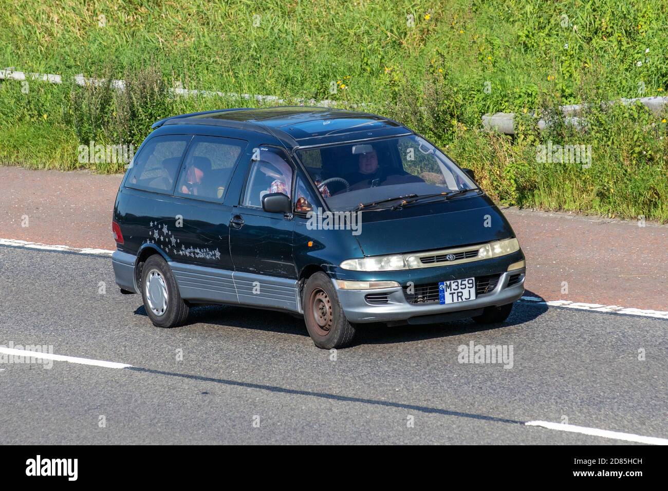 1994 90s nineties green Toyota Estima MPV;  Vehicular traffic, moving vehicles, cars, vehicle driving on UK roads, 1990s motors, motoring on the M6 motorway highway UK road network. Stock Photo