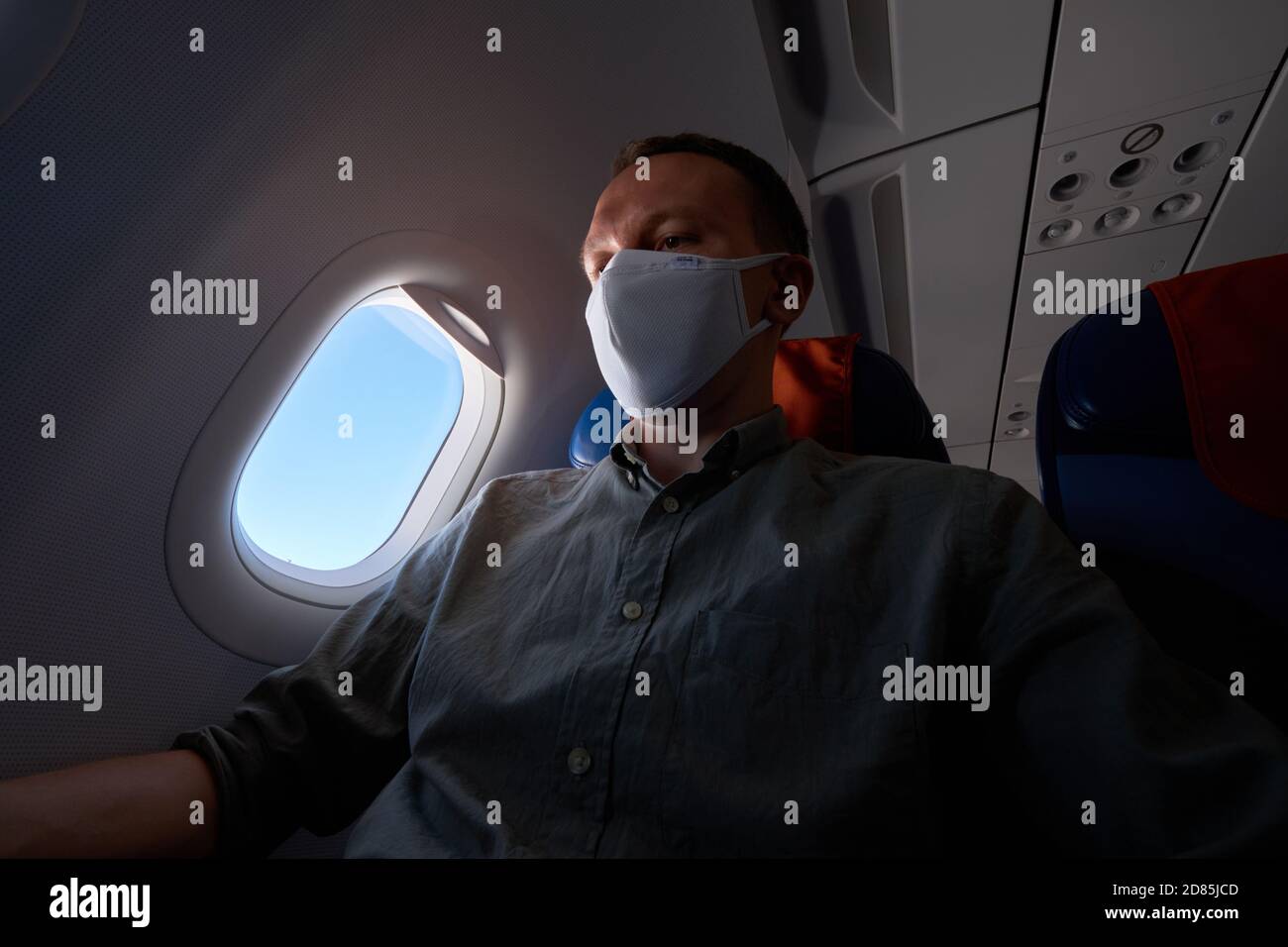 Passenger wearing mask in an airplane Stock Photo