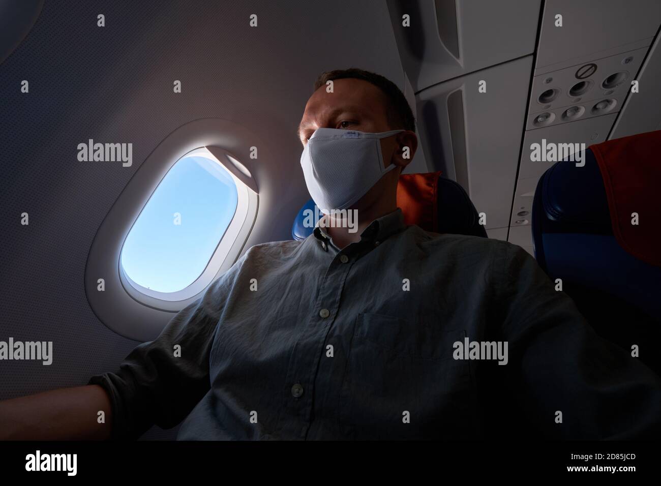 Passenger wearing mask in an airplane Stock Photo Alamy
