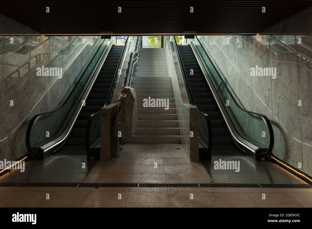 large empty underground passage with escalators Stock Photo