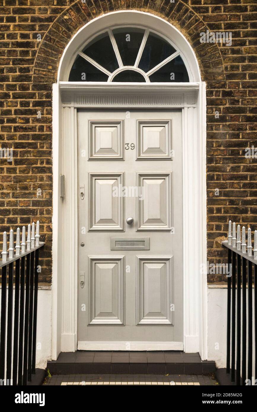 A panelled wooden door on a town house. The door has been