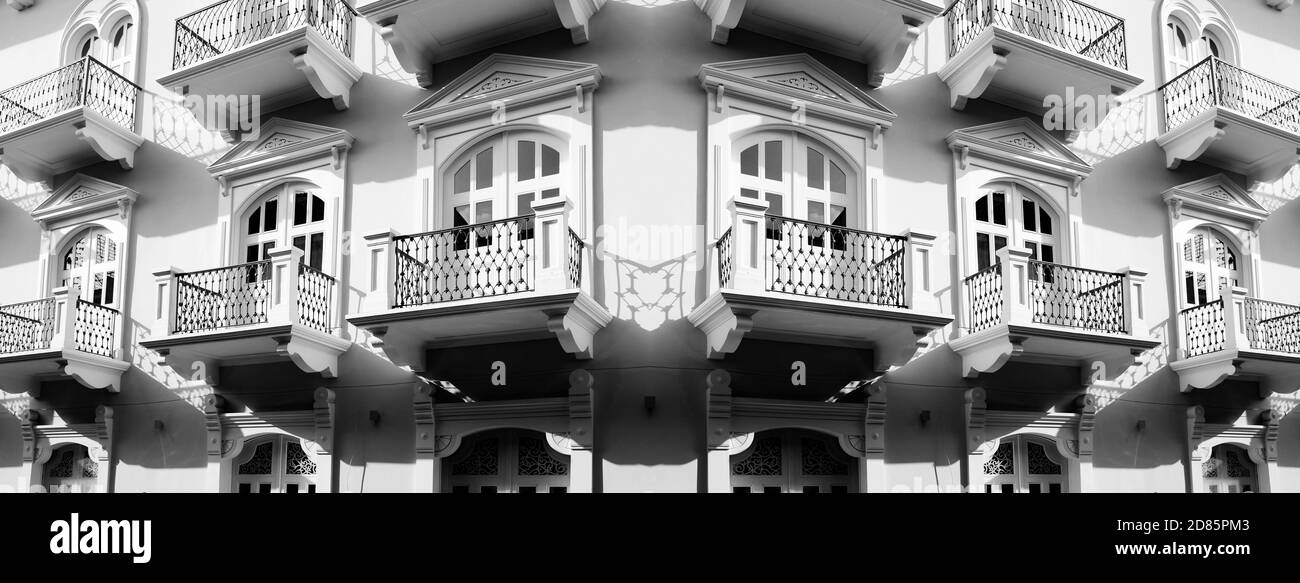 Detail of old balconies balcony on building with decorative windows and doors in apartment or hotel Stock Photo