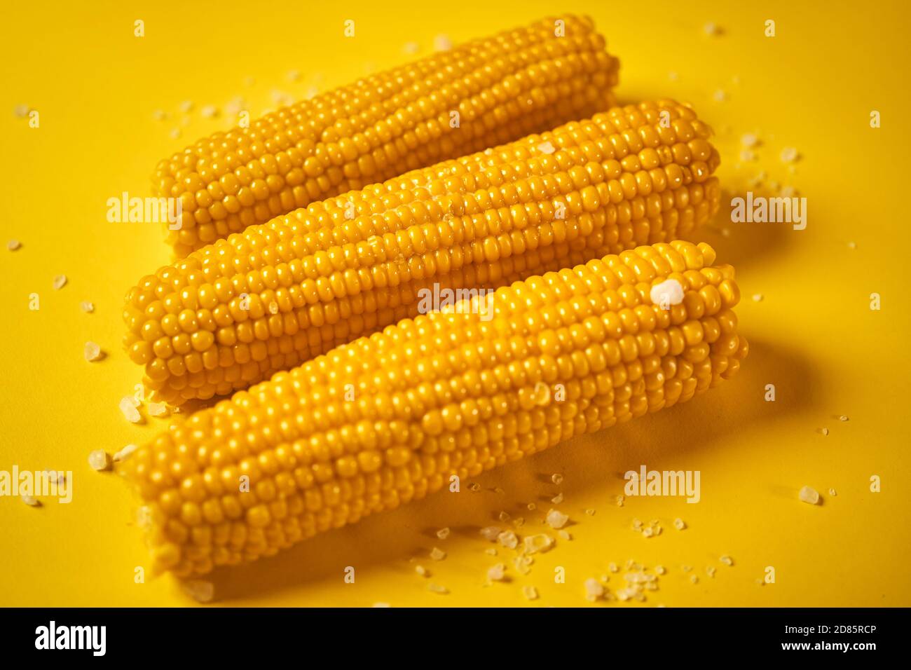 delicious boiled sweet corn on yellow background Stock Photo