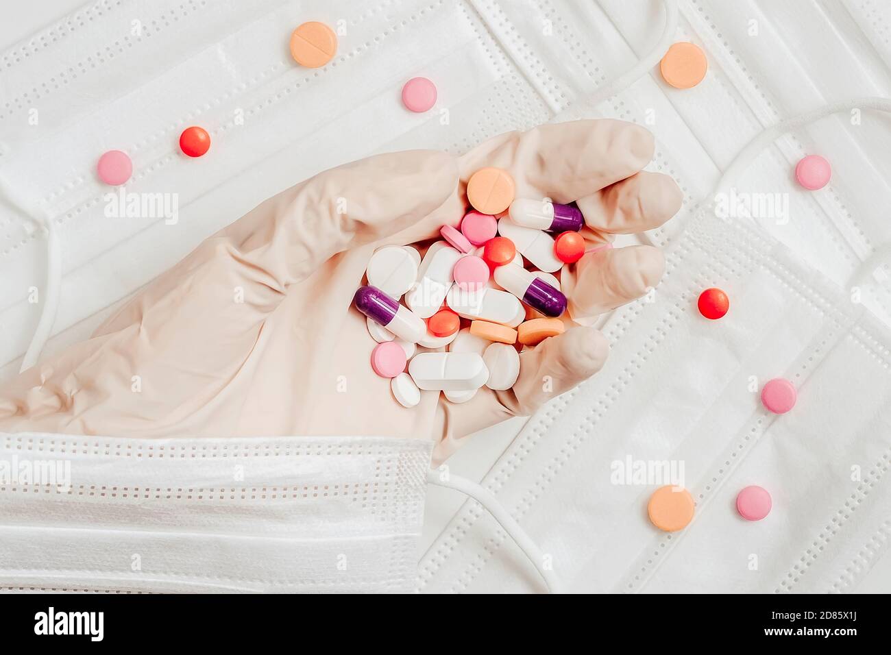 Medical Protection Hand Hand in protective glove with pills of different colors on background ...