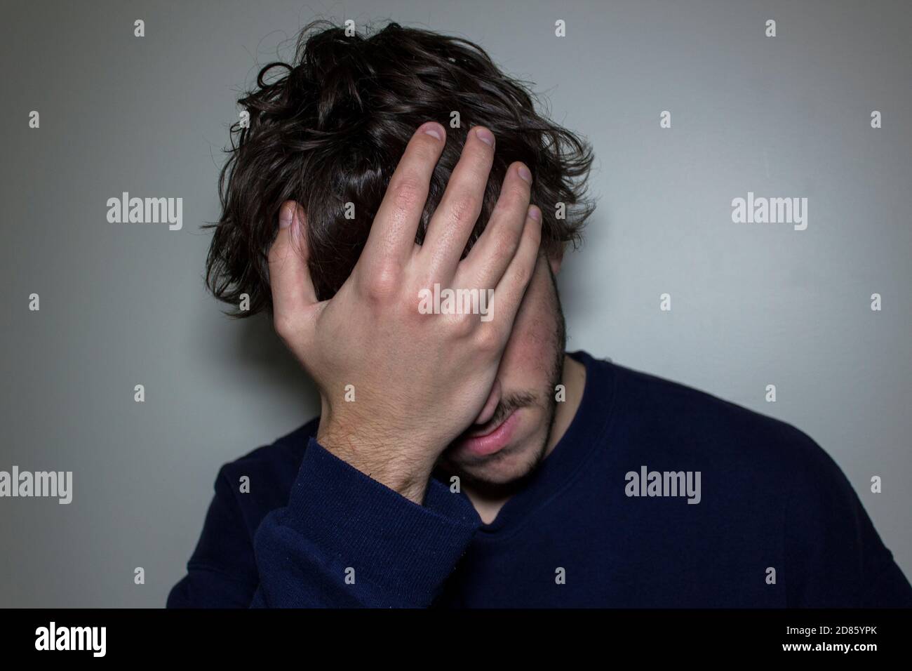 Person with Hand on Face in Disbelief Stock Photo