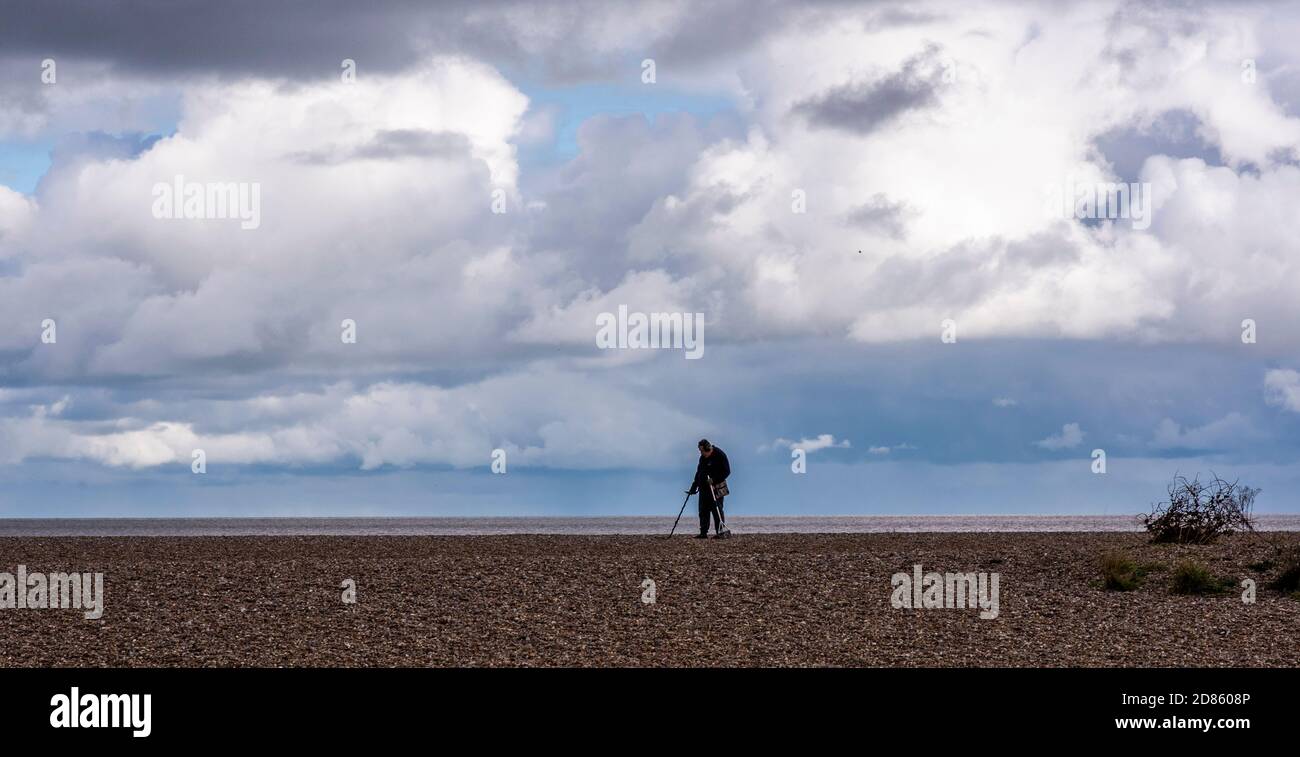 Man using metal detector on beach, Southwold, Suffolk, UK Stock Photo