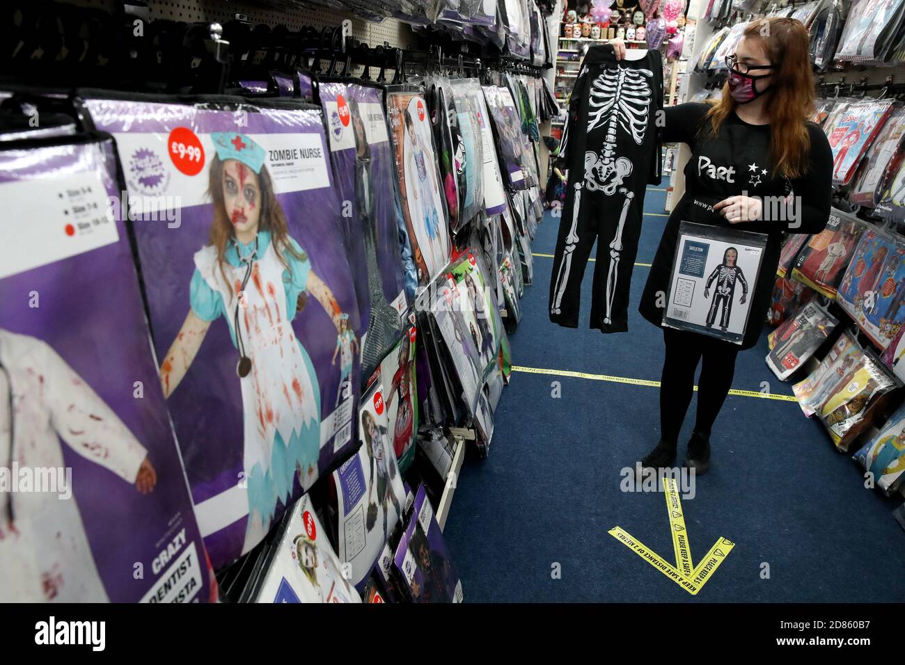 Sales assistant Emily Macquarrie adjusts the display of Halloween