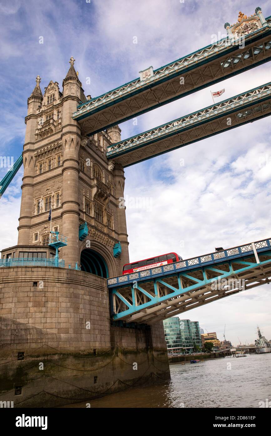 UK, London, Tower Bridge, view up from boat passing below tilting deck with London bus crossing Stock Photo
