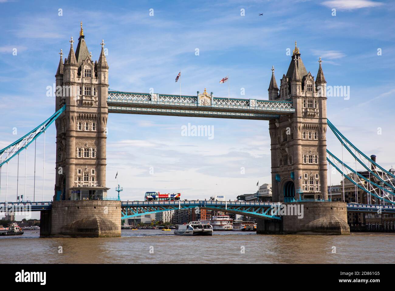 UK, London, River Thames, Thames Clipper boat passing below Tower Bridge Stock Photo