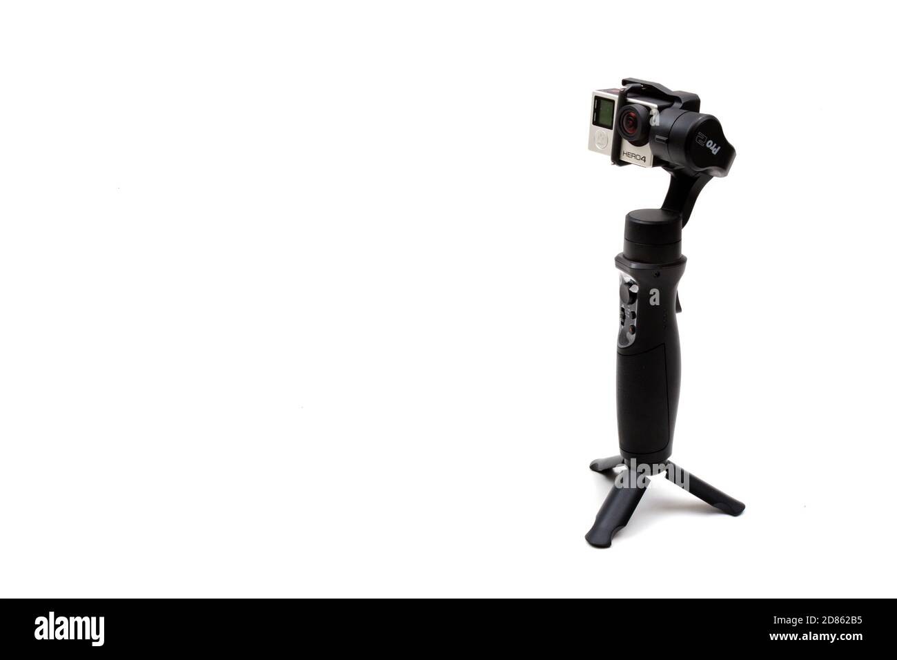 London, United Kingdom, 21st September 2020:- An isteady gimbal with a GoPro Hero4 camera isolated on a white background Stock Photo