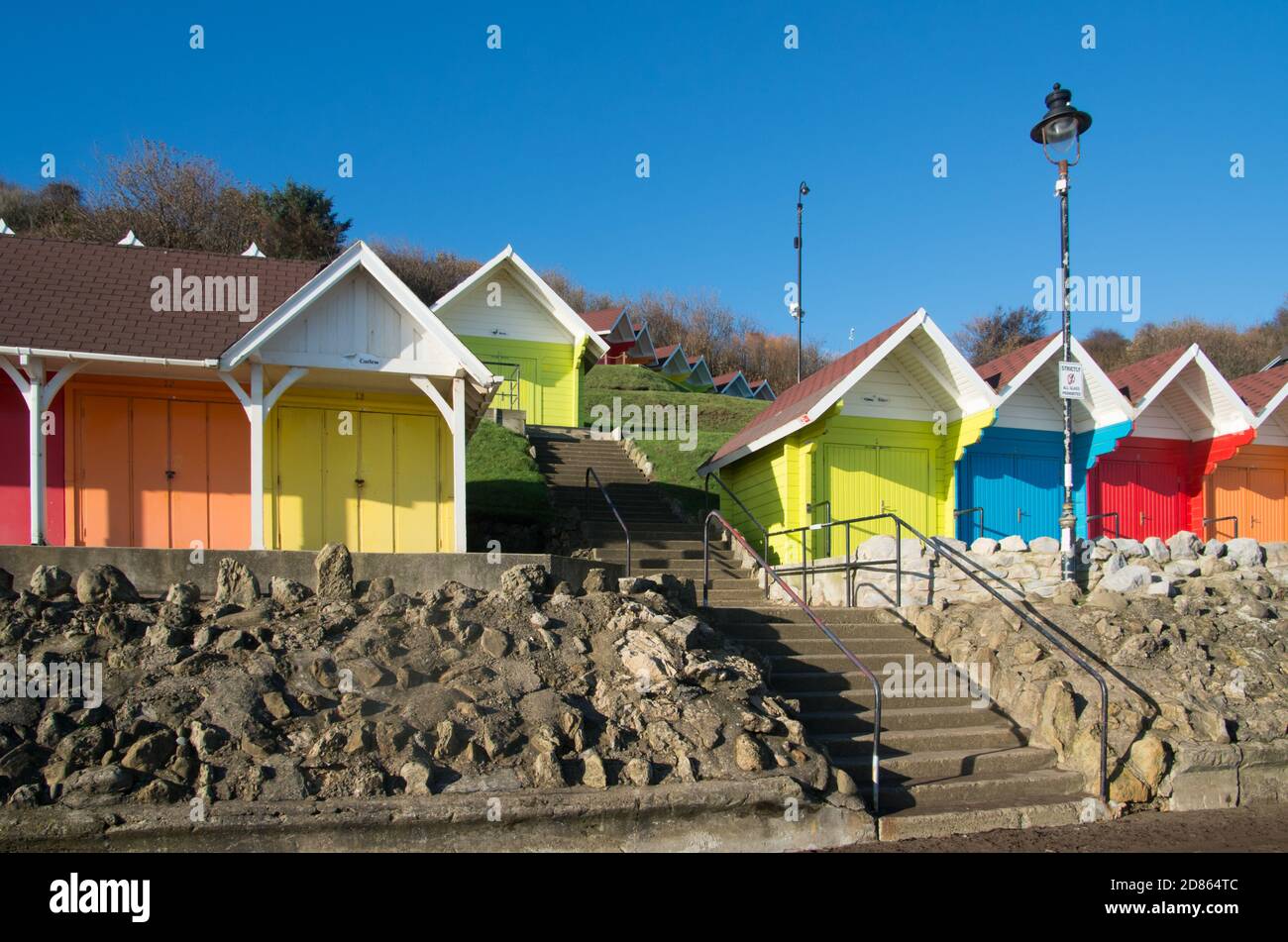 Brightly coloured beach huts, seaside town of Scarborough, North Yorkshire, UK Stock Photo