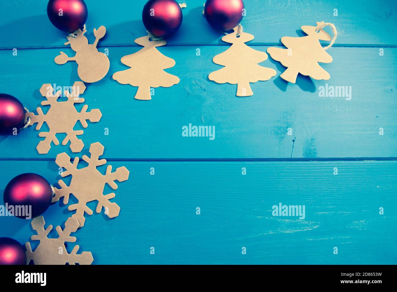 Merry Christmas greeting card, on a blue wooden background, with various objects and with space on the right where you can write a message Stock Photo