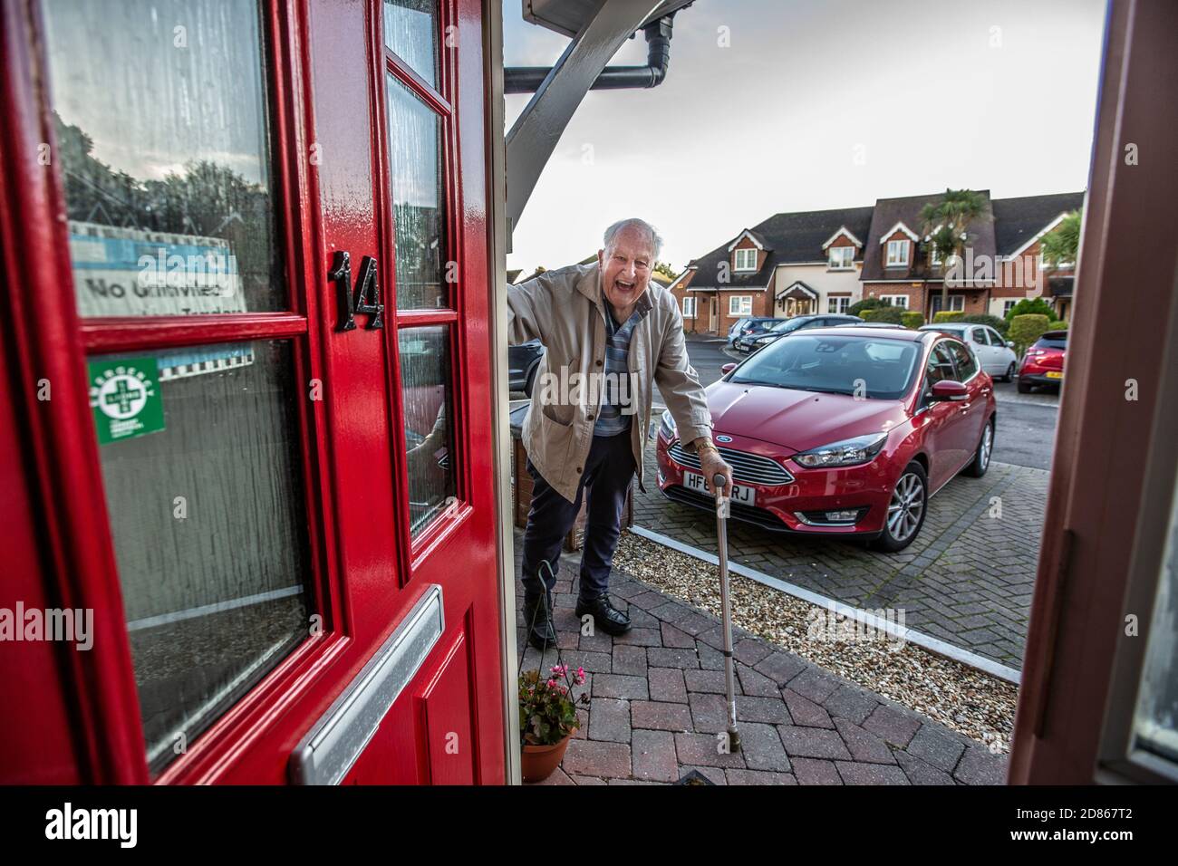 Elderly man in his 80's entering his home using a walking aid, Dorset, Southwest England, United Kingdom Stock Photo