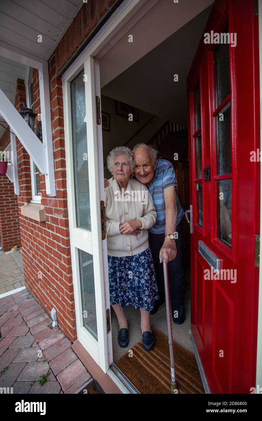 Elderly couple in their 80's stood in their doorway, Southwest England, United Kingdom Stock Photo