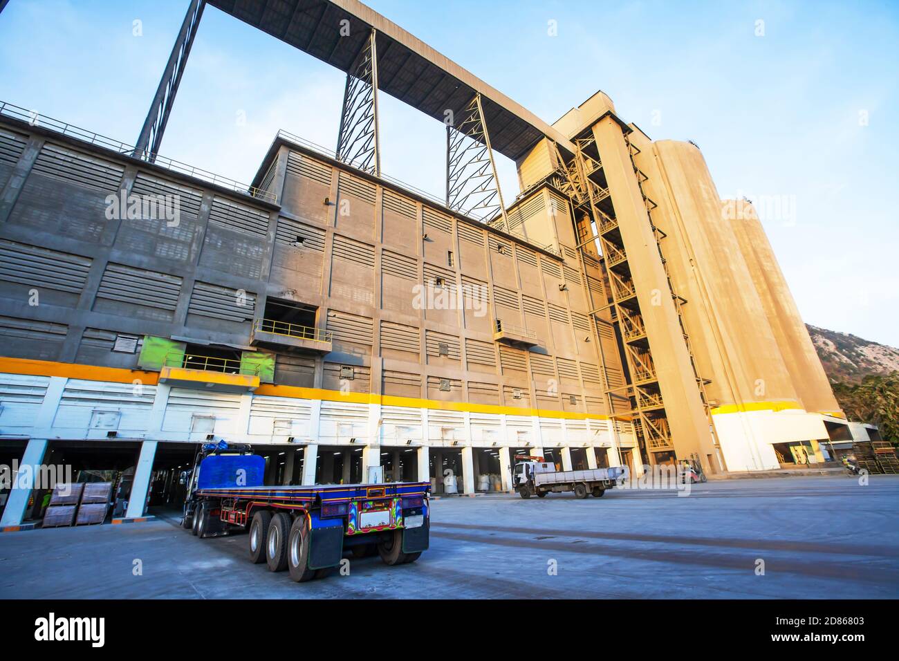 Horizontal view of heavy truck parked in front of the cement warehouse