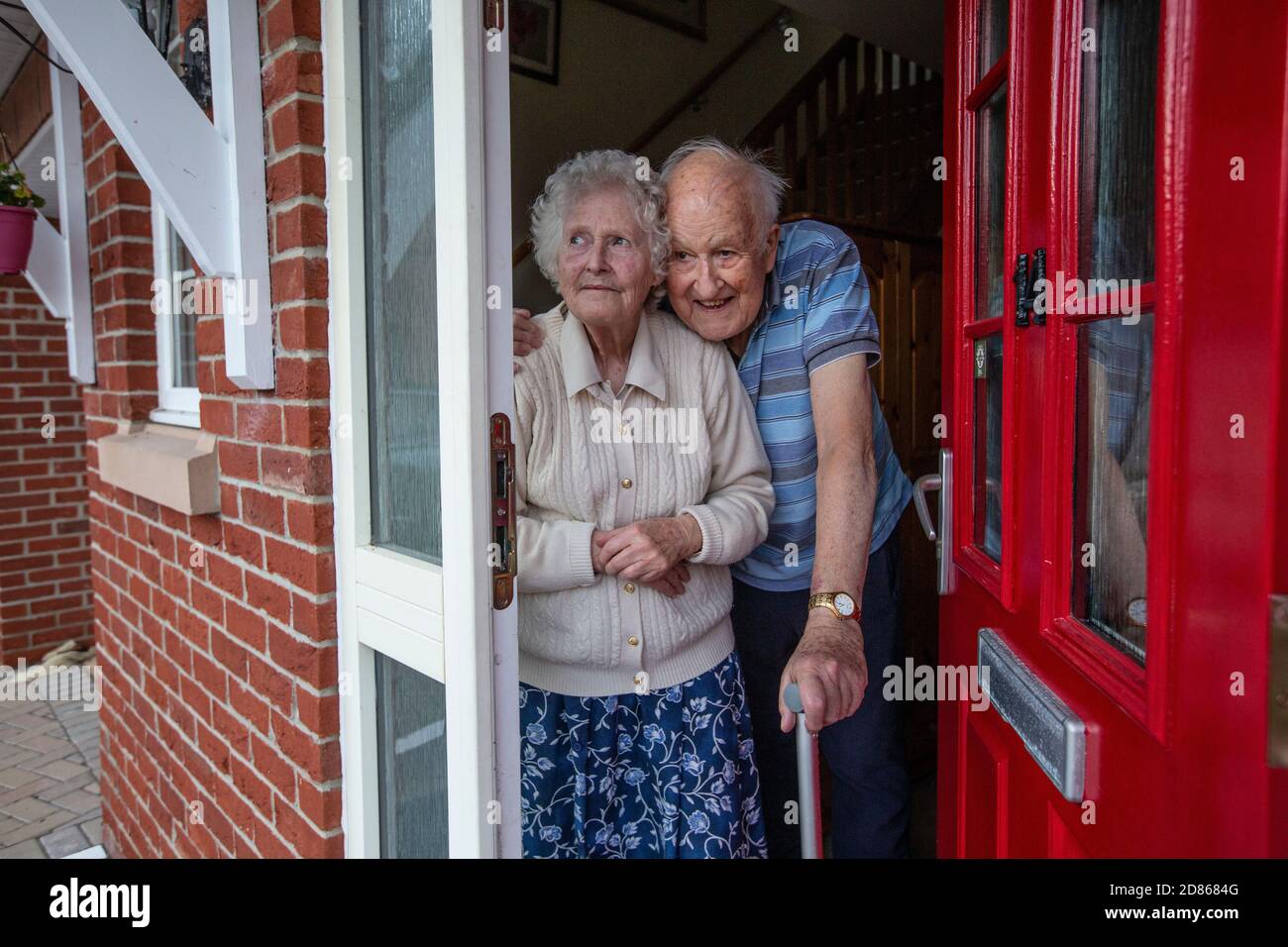 Elderly couple in their 80's stood in their doorway, Southwest England, United Kingdom Stock Photo