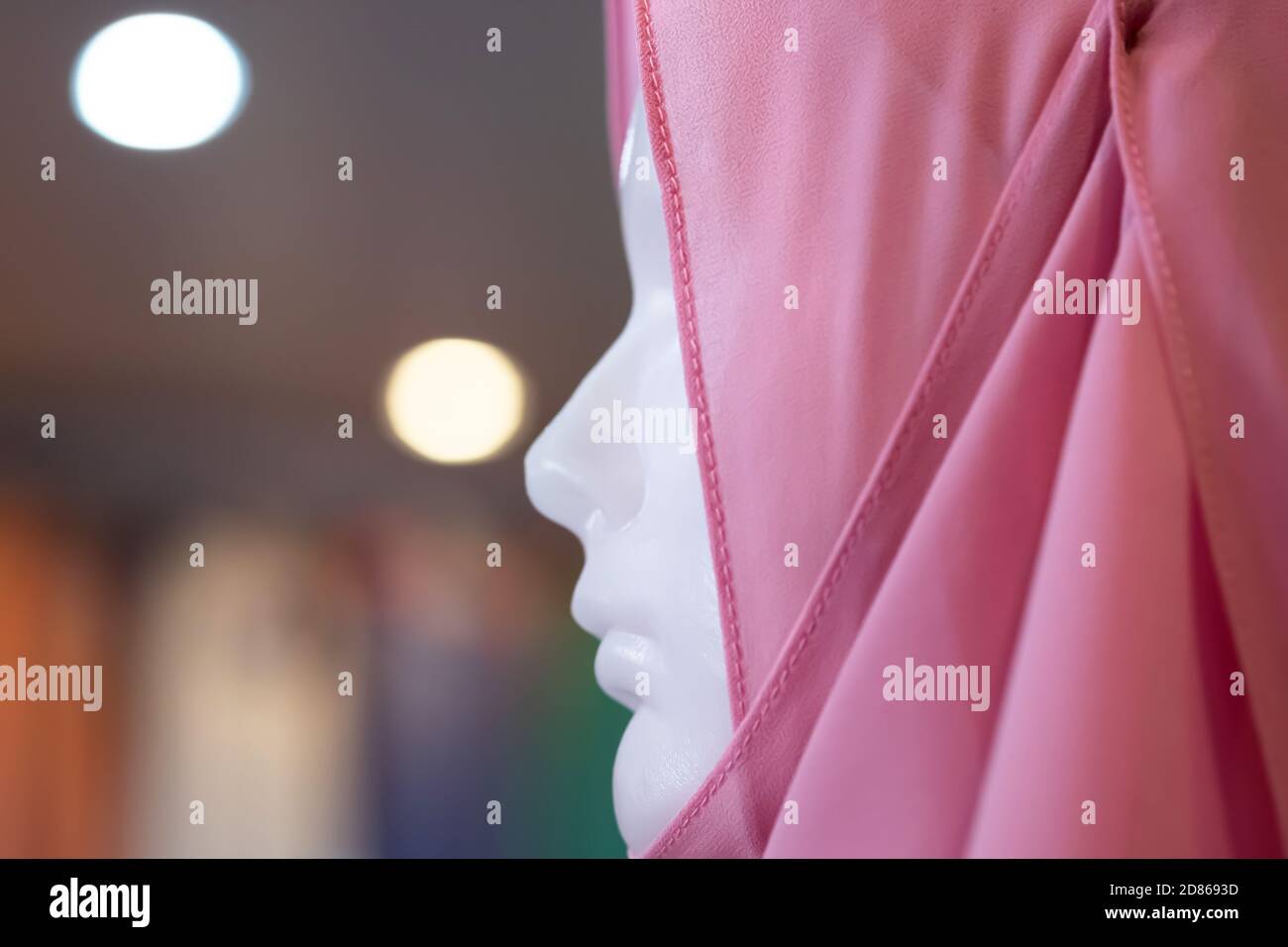 Close-up female Muslim mannequin in hijab display in a fashion house. Soft focus on hijab. Stock Photo