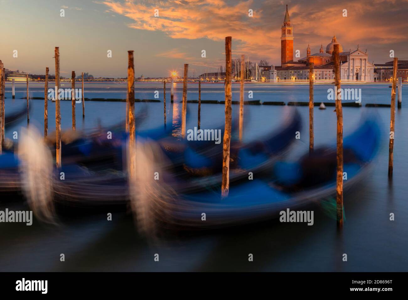 Moored gondolas with San Giorgio Maggiore island in the background at sunset, Venice, Veneto, Italy Stock Photo