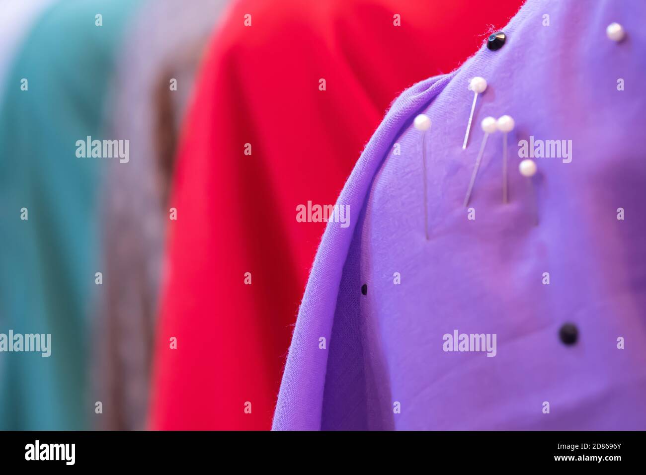 Closeup a mannequin in a fashion colours sewing pins lace to