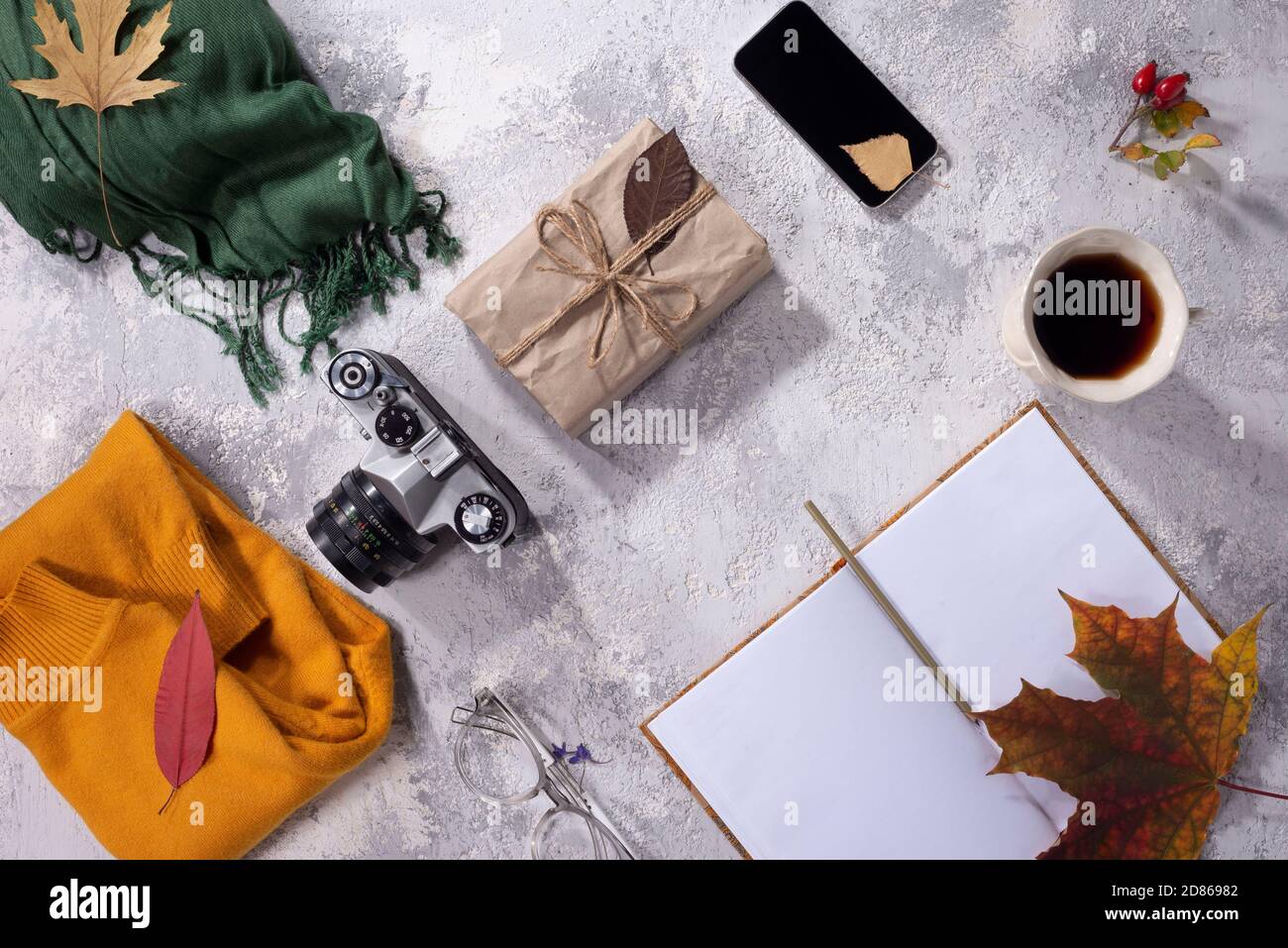 autumn flatlay of clothes in warm yellow and gray-white shades Women's fashion clothes and accessories on white background. Flat lay female golden sty Stock Photo