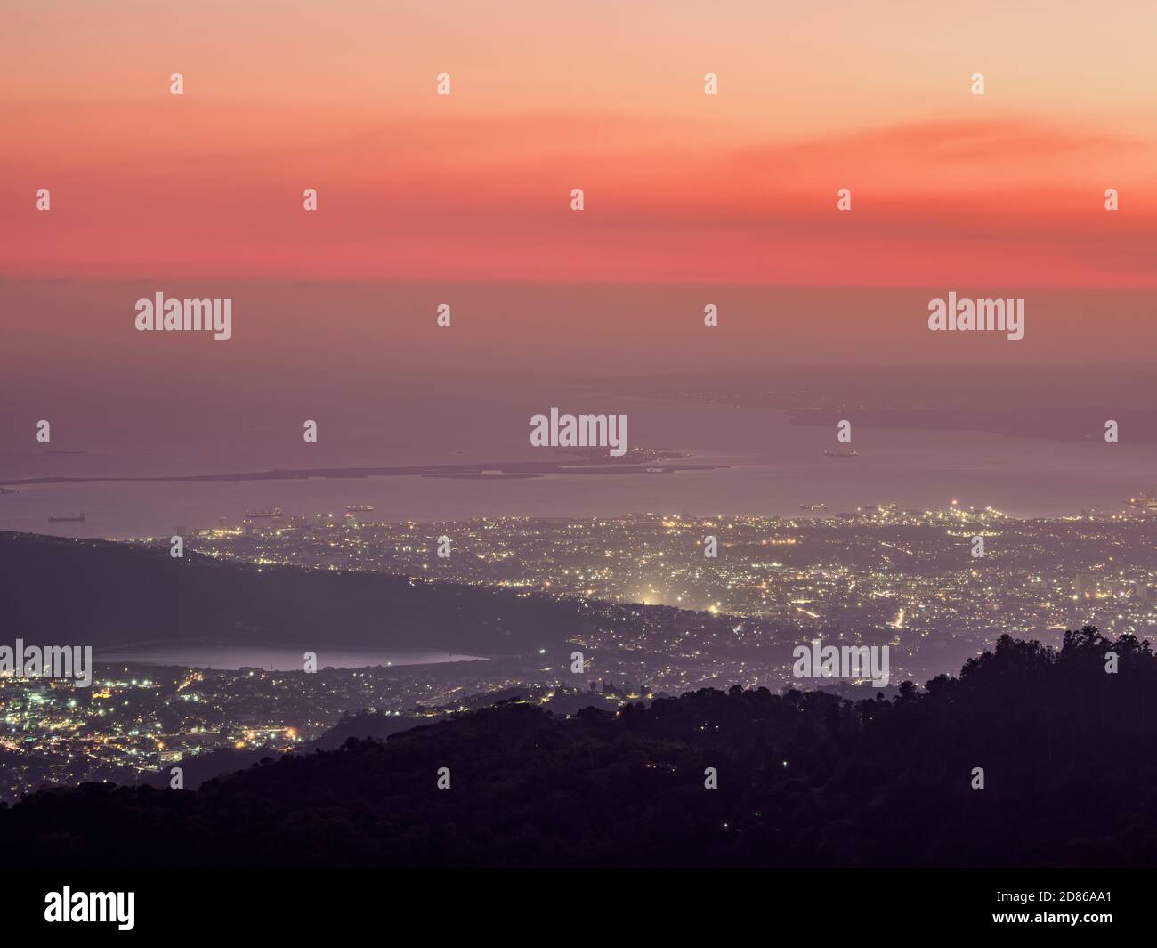 View over Blue Mountains towards Kingston at sunset, Saint Andrew Parish, Jamaica Stock Photo