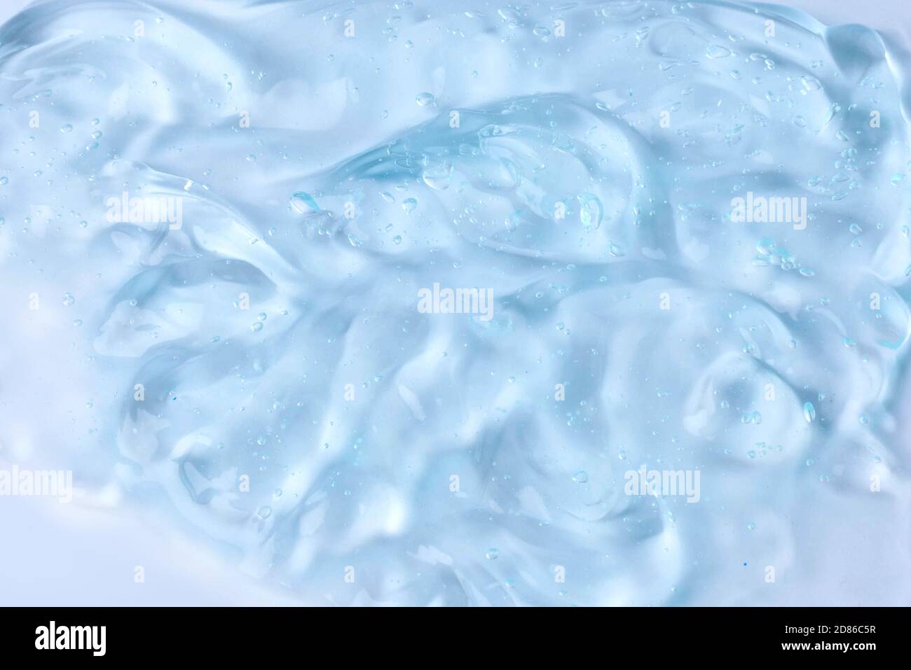 A sample of a cosmetic product. Hyaluronic acid gel. Textured background with oxygen bubbles. Cream gel cosmetic lubricant . Stock Photo