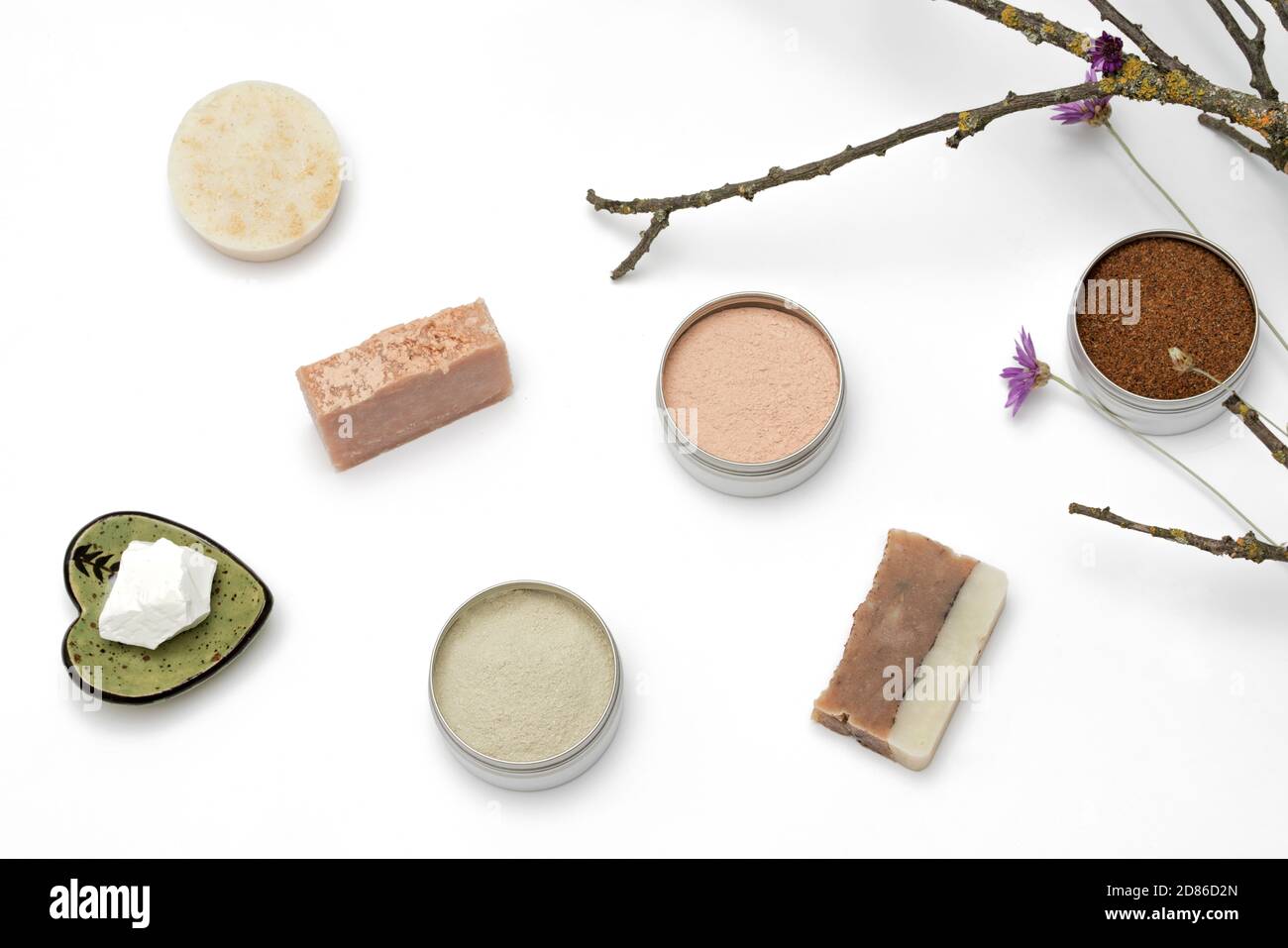 Ingredients for the production of cosmetics on a white background. Clays, wax, herbal powders, dried flowers, raspberry ketone. Natural cosmetics concept. Stock Photo