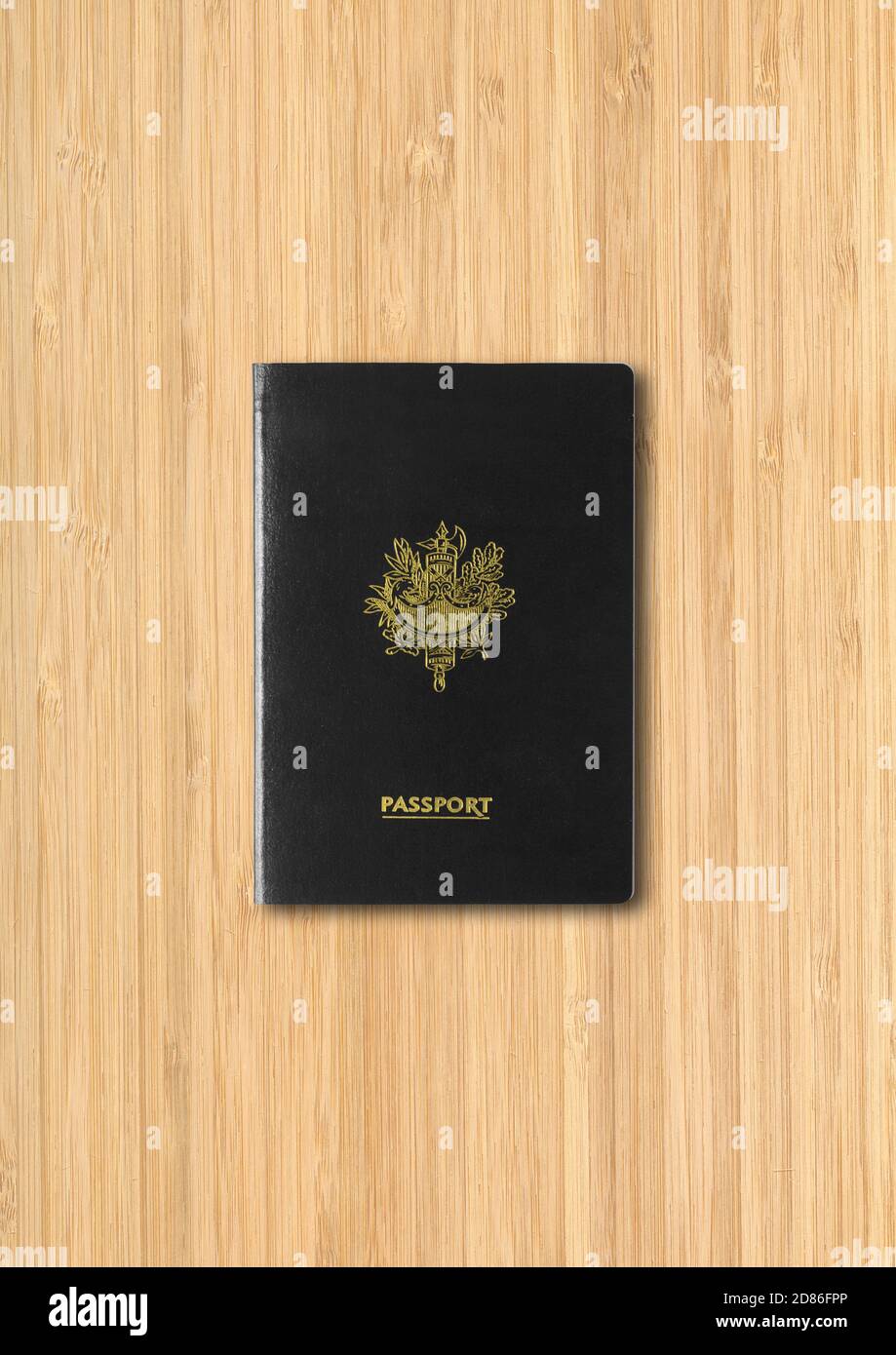 Generic black passport isolated on wooden background Stock Photo