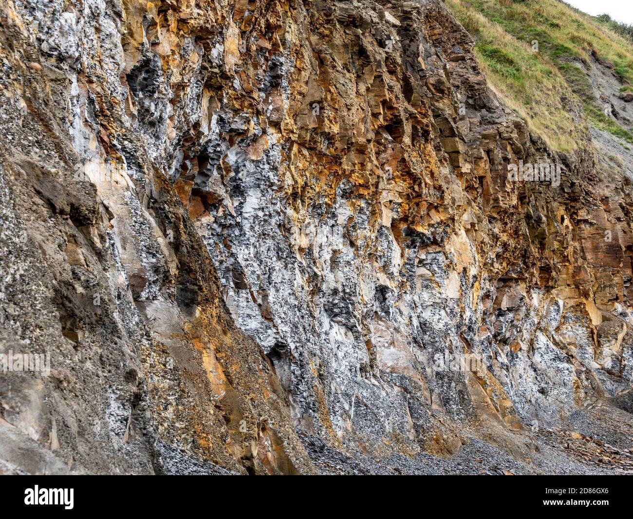 Red Ironstone and Grey shale rock in cliff at Runswick Bay, North Yorkshire Coast, UK. Stock Photo