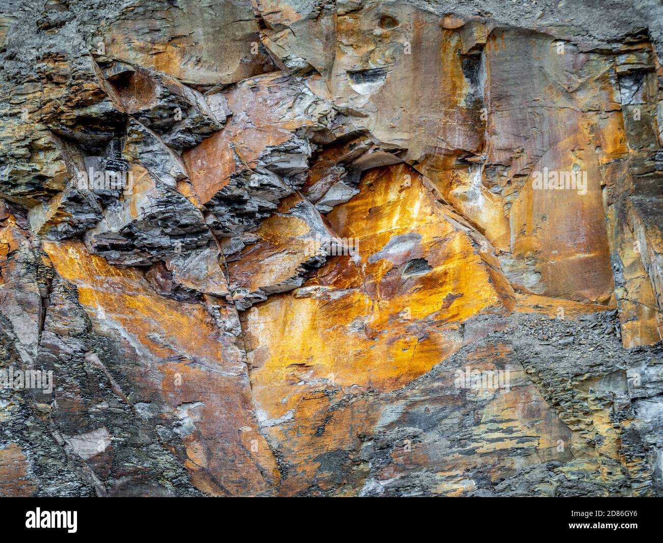 Red Ironstone and Grey shale rock in cliff at Runswick Bay, North Yorkshire Coast, UK. Stock Photo