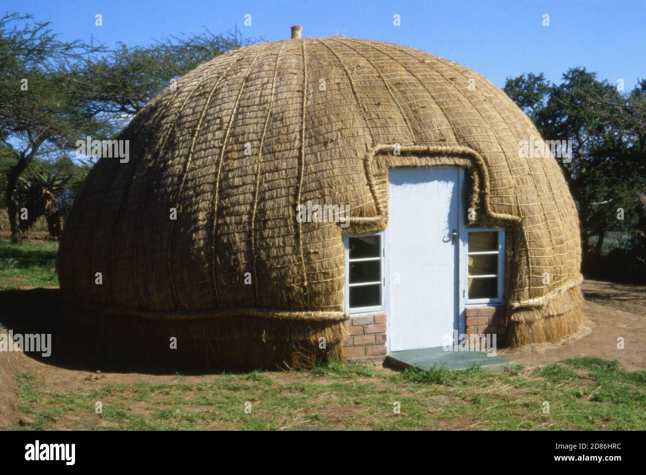 Traditional Kraal hut, but with modern door and windows for tourist accommodation, South Africa 1981 Stock Photo